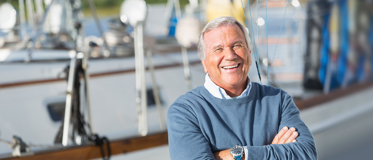 Photo of retired man near his boat - concept: Client Suitability for DFL Fiduciary Services